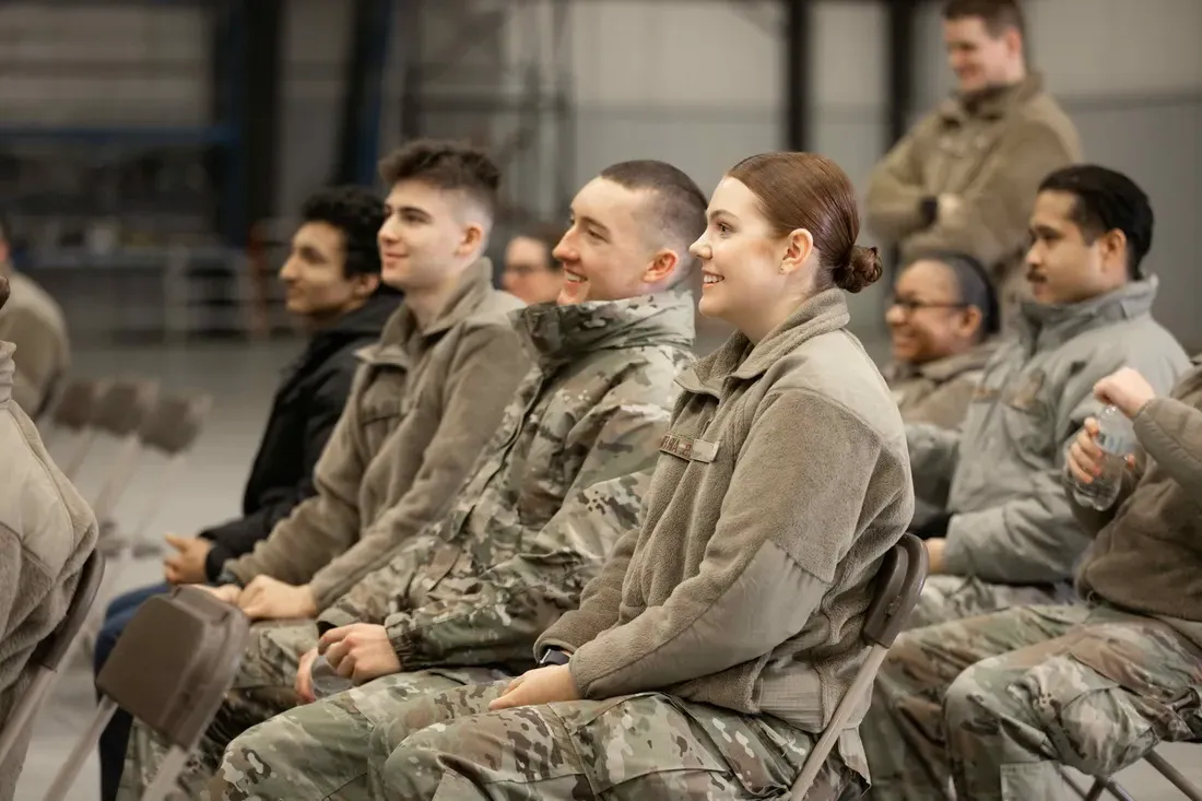 ROTC students siting and smiling.